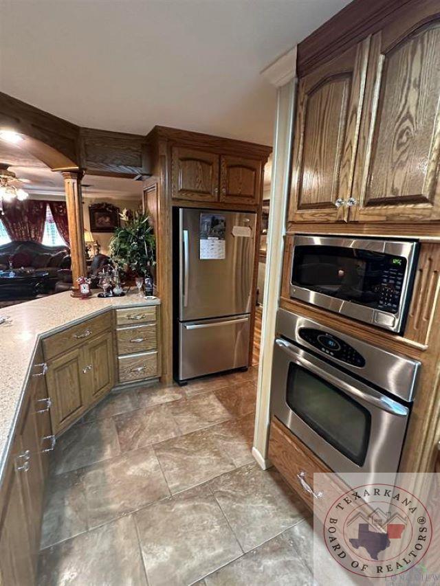 kitchen with decorative columns and stainless steel appliances