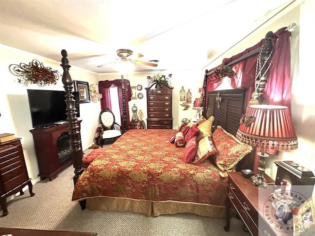 bedroom with ceiling fan, crown molding, and carpet floors