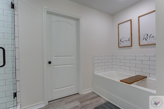 bathroom featuring a bathtub and hardwood / wood-style floors