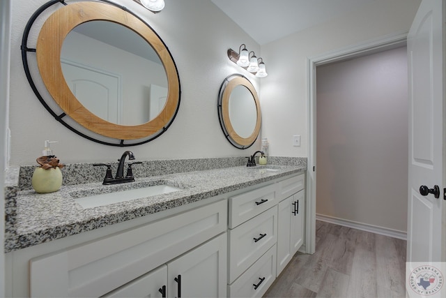 bathroom with vanity and hardwood / wood-style floors