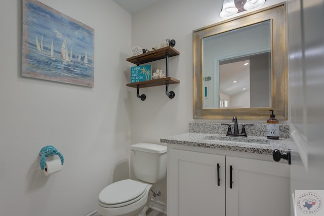 bathroom featuring vanity and toilet