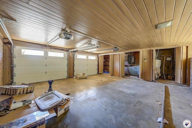 garage featuring a garage door opener, electric panel, and wooden ceiling