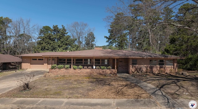 ranch-style home featuring an attached garage and driveway