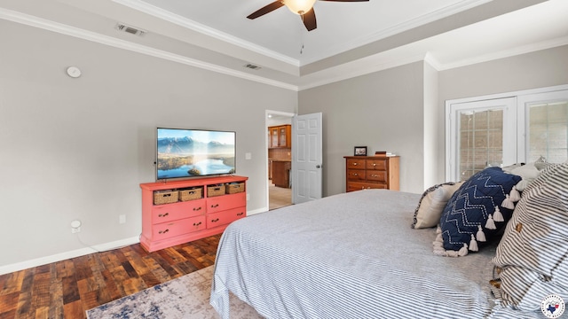 bedroom featuring visible vents, ornamental molding, wood-type flooring, and baseboards