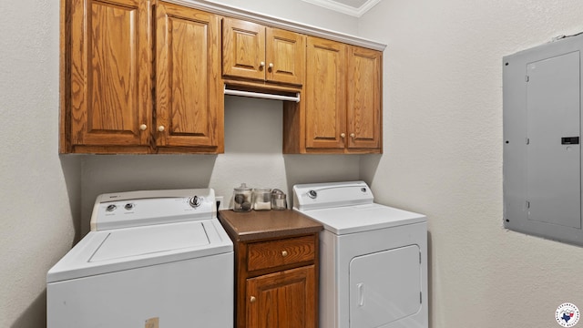 laundry room featuring washer and clothes dryer, cabinet space, electric panel, and ornamental molding