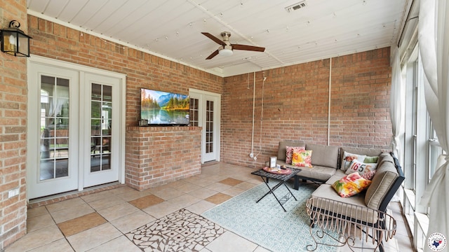 sunroom with french doors, ceiling fan, an outdoor living space, and visible vents