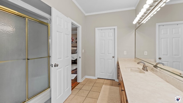 bathroom with crown molding, vanity, baseboards, tile patterned floors, and a shower with shower door