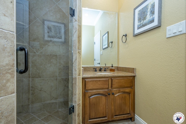 bathroom featuring vanity, crown molding, and a shower stall