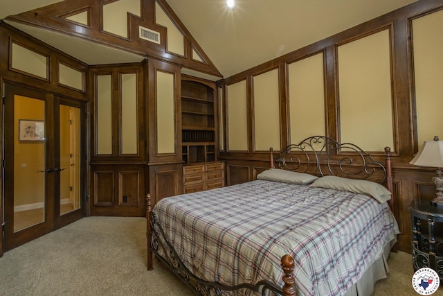 bedroom featuring high vaulted ceiling, visible vents, french doors, and light colored carpet