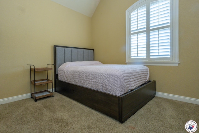 carpeted bedroom featuring baseboards and lofted ceiling