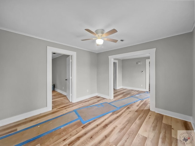 unfurnished room featuring ceiling fan, light hardwood / wood-style flooring, and crown molding