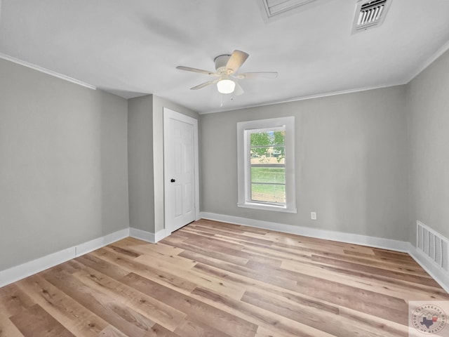 spare room with ceiling fan, ornamental molding, and light hardwood / wood-style floors