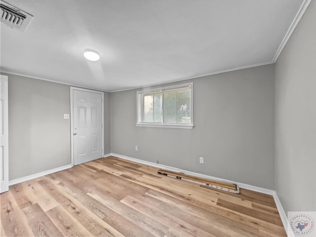 spare room with light hardwood / wood-style floors and ornamental molding