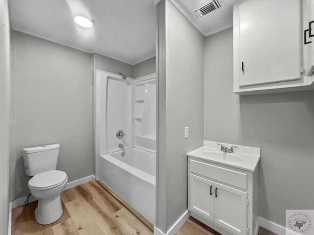 full bathroom with tub / shower combination, hardwood / wood-style floors, toilet, and vanity