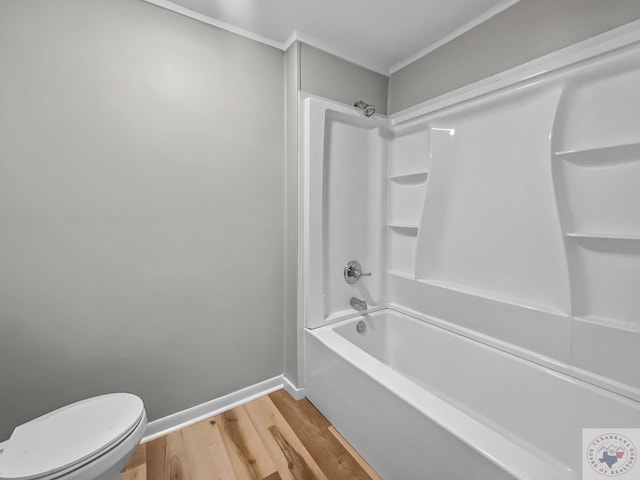 bathroom featuring toilet, hardwood / wood-style floors, and shower / bathing tub combination