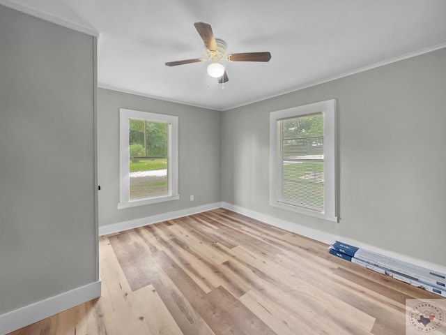 empty room featuring light hardwood / wood-style floors, ornamental molding, and ceiling fan