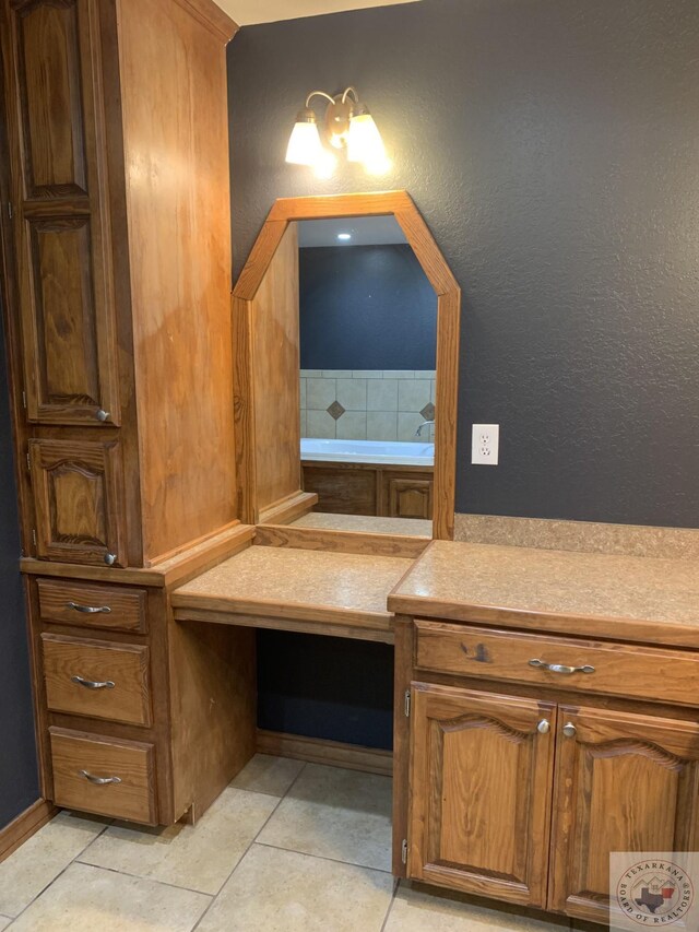 bathroom with tile patterned floors and tasteful backsplash