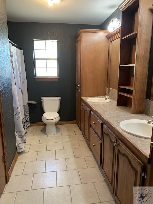 bathroom with tile patterned floors, toilet, and vanity