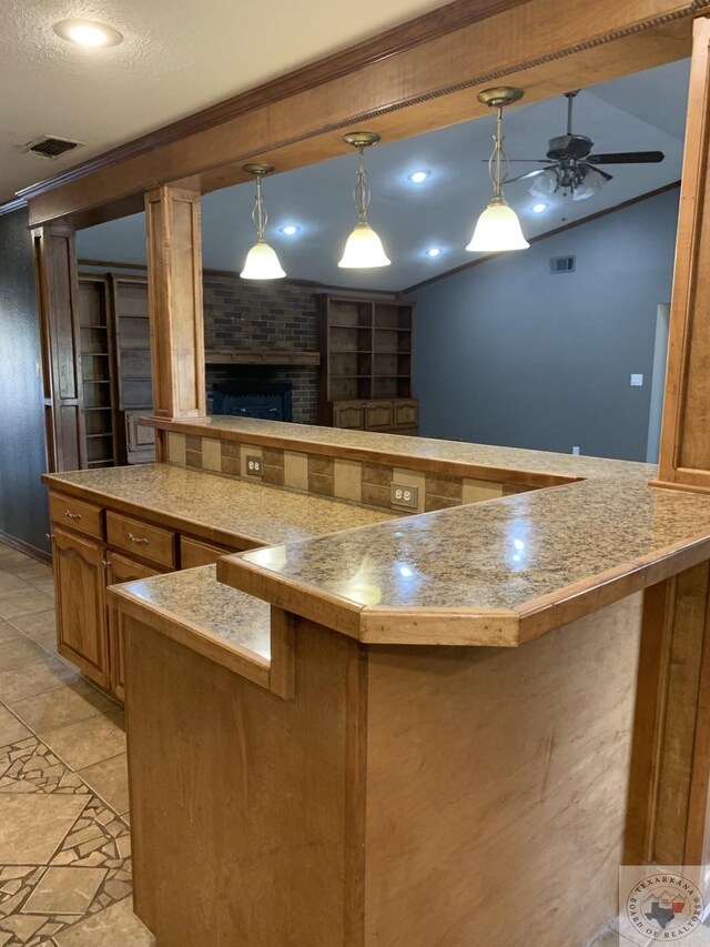 kitchen with ceiling fan, crown molding, and pendant lighting