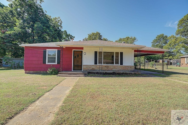 view of front of property with a front yard and a carport