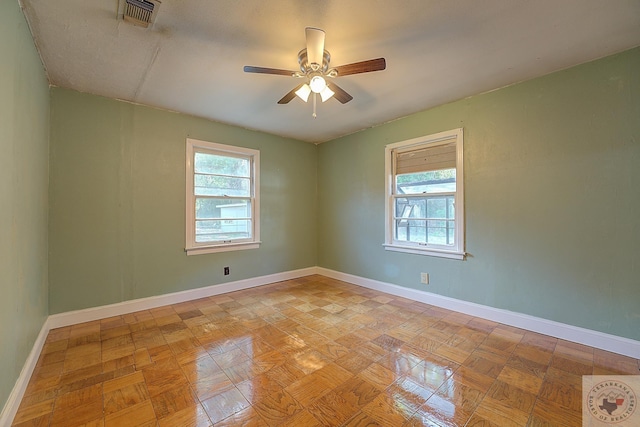 unfurnished room with light parquet floors and ceiling fan