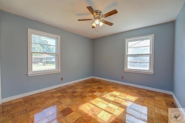 unfurnished room with plenty of natural light and ceiling fan