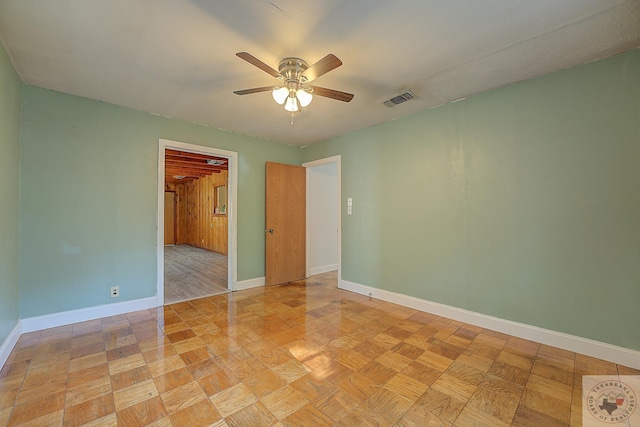 empty room with light parquet floors and ceiling fan