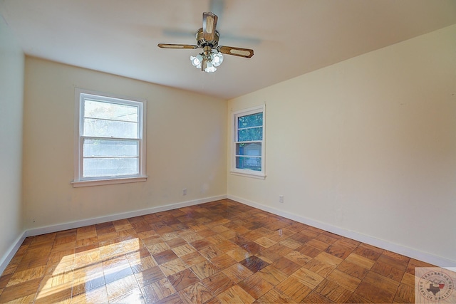 empty room featuring light parquet floors and ceiling fan