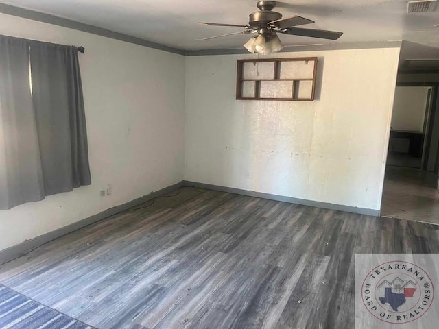 unfurnished room with ceiling fan and dark hardwood / wood-style flooring