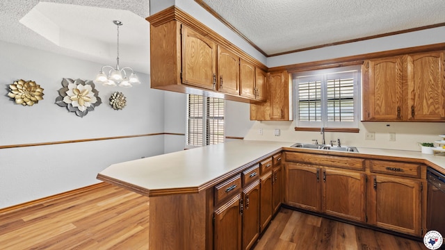 4707 Charleston St, Texarkana, AR 71854 - kitchen with a sink, a peninsula, a textured ceiling, dark wood-style floors, and brown cabinets