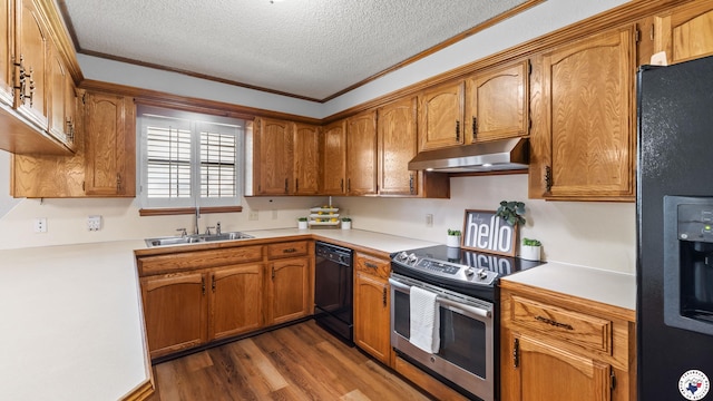 4707 Charleston St, Texarkana, AR 71854 - kitchen featuring under cabinet range hood, black appliances, a sink, dark wood-style flooring, and light countertops