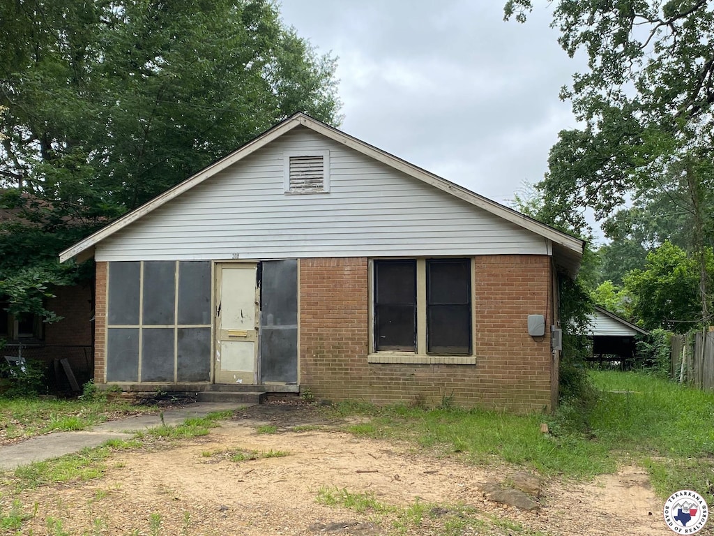 308 E 26th St, Texarkana, AR 71854 - view of front of property featuring brick siding and a sunroom