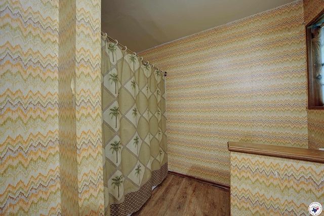 bathroom with a shower with curtain and wood finished floors