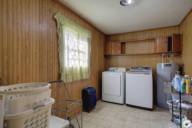 clothes washing area featuring water heater, light floors, wooden walls, crown molding, and a textured ceiling