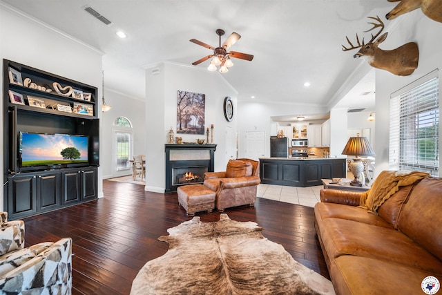 215 Hunters Cv, Texarkana, TX 75503 - living area featuring ornamental molding, wood-type flooring, a ceiling fan, a warm lit fireplace, and baseboards