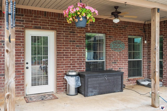 215 Hunters Cv, Texarkana, TX 75503 - doorway to property with brick siding, a ceiling fan, and a patio area