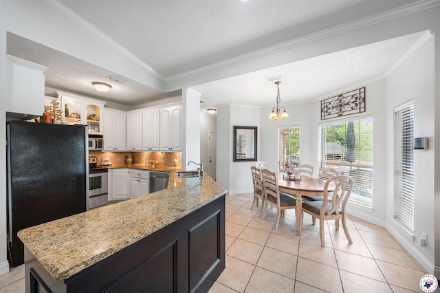 215 Hunters Cv, Texarkana, TX 75503 - kitchen with appliances with stainless steel finishes, a sink, white cabinets, tasteful backsplash, and crown molding