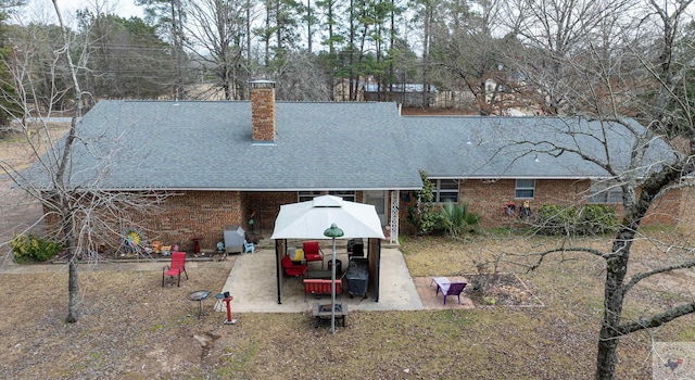 back of house featuring a gazebo and a patio