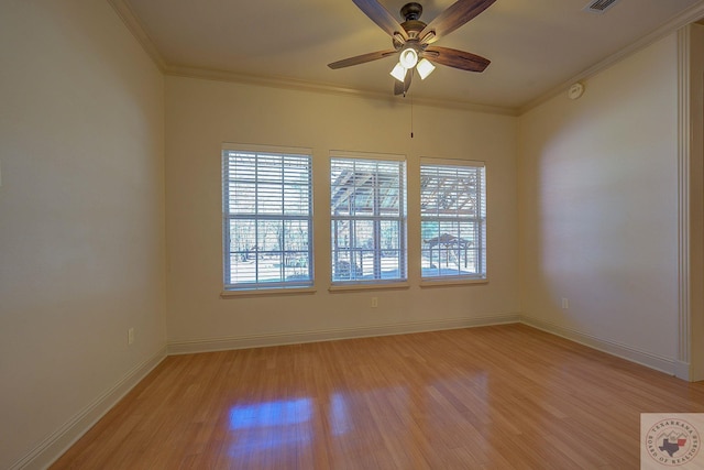 spare room featuring ceiling fan, crown molding, and light wood-type flooring