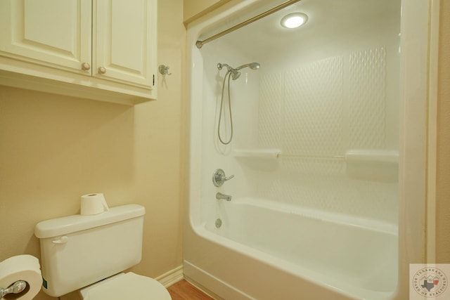 bathroom with toilet and bathing tub / shower combination