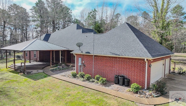 rear view of house with a garage, a lawn, and a porch