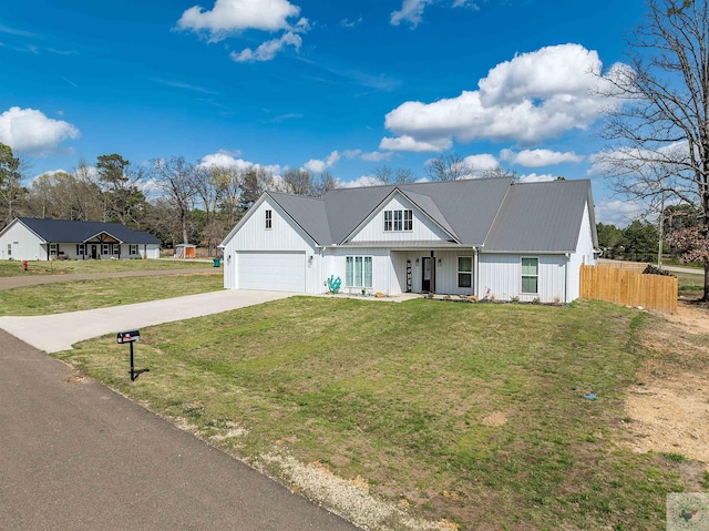 view of front of home with a garage and a front lawn