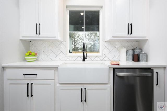 kitchen featuring sink, dishwasher, white cabinetry, and tasteful backsplash