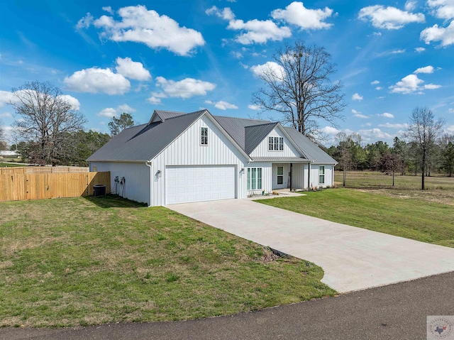 modern inspired farmhouse featuring a garage and a front lawn