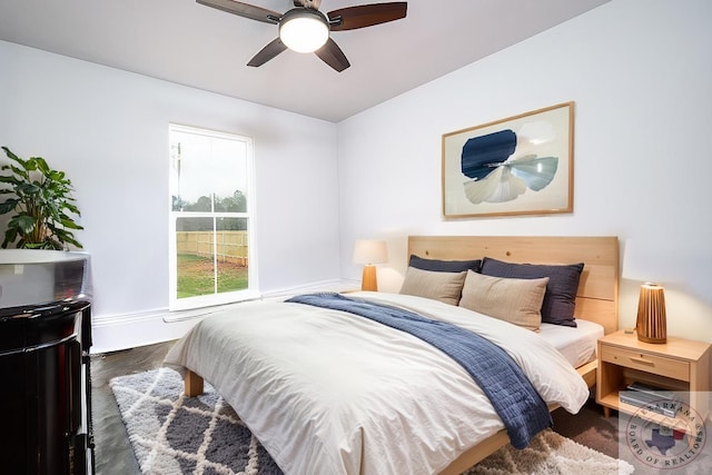 bedroom with ceiling fan and dark hardwood / wood-style flooring