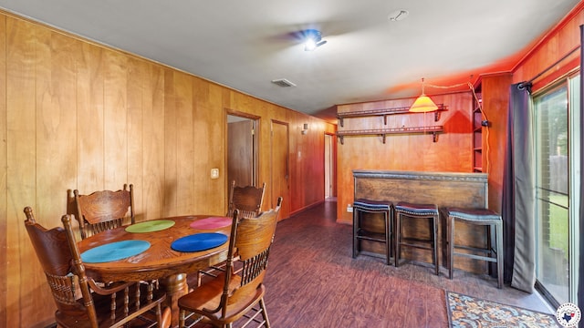 119 Hall St, New Boston, TX 75570 - dining space featuring wood walls, wood finished floors, and a dry bar