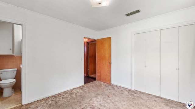 119 Hall St, New Boston, TX 75570 - unfurnished bedroom with carpet floors, a closet, connected bathroom, crown molding, and tile walls