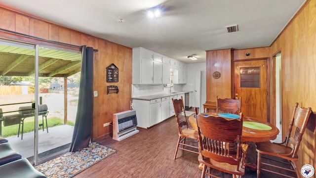 119 Hall St, New Boston, TX 75570 - dining area with heating unit, wood walls, and dark wood-style floors