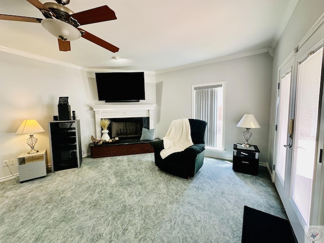 sitting room featuring crown molding, ceiling fan, and carpet