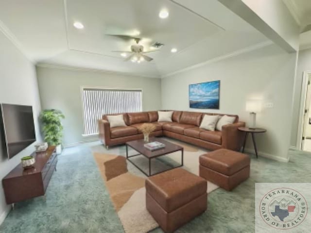 living room with ceiling fan, a raised ceiling, ornamental molding, and light carpet